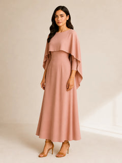 Blush pink cape maxi dress by WAROODI with elegant A-line silhouette, three-quarter view
