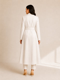 Celeste Prestige Belted Coat in Ivory Pearl back view, longline luxury modest coat with waist belt, smooth fully lined structure, full-length flow, and refined WAROODI outerwear design.