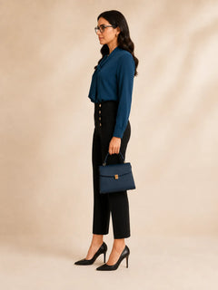 WAROODI Elise Tie-Neck Blouse in teal blue styled with black trousers and handbag, side view