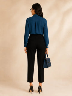Back view of WAROODI Elise Tie-Neck Blouse in teal blue with long sleeves and tailored styling