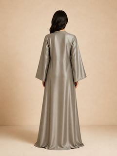 Layali Satin Embellished Kaftan by WAROODI back view, full-length silver grey satin kaftan with smooth flowing drape, relaxed modest fit, wide sleeves, and polished luxury evening finish.
