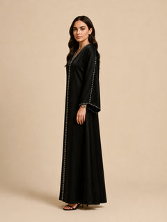Layali Black Satin Embellished Kaftan by WAROODI side view, black satin modest kaftan with relaxed wide sleeves, soft flowing A-line drape, subtle shine, and refined eveningwear silhouette.