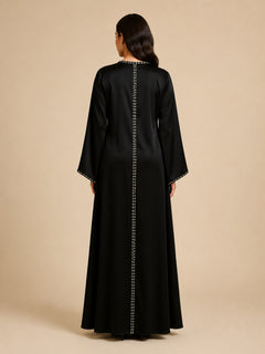 Layali Black Satin Embellished Kaftan by WAROODI back view, full-length black satin kaftan with smooth flowing structure, relaxed modest fit, wide sleeves, and polished luxury evening finish.