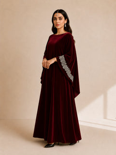 Malika Velvet Kaftan by WAROODI three-quarter view, showing the rich velvet texture, graceful drape, wide sleeve cut, crystal sleeve detailing, and refined modest luxury design.