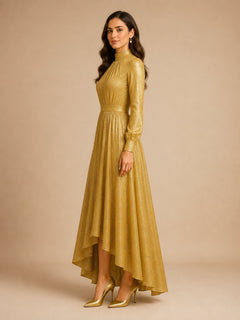 Golden Aura Shimmer Gown by WAROODI side view, modest shimmer evening gown with full-length sleeves, waist-defining band, graceful fabric drape, high-low hem movement, and refined luxury silhouette.