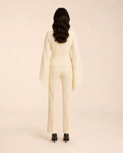 Back view of WAROODI Valeria Cape Co-ord Set in ivory cream with cape sleeves and straight-leg trousers