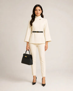 WAROODI Valeria High-Neck Cape Co-ord Set in ivory cream with black belt and tailored trousers, front view