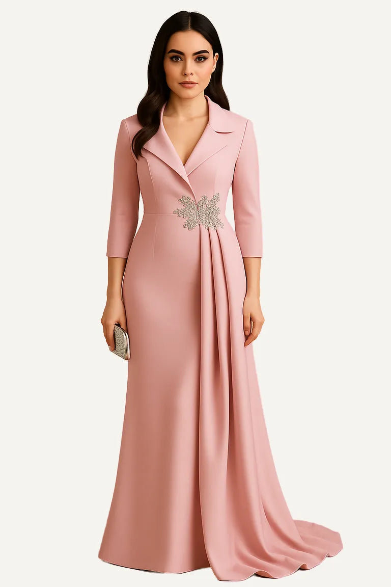 WAROODI Celestia Draped Gown in Blush Pink – lapel neckline, 3/4 sleeves, draped side panel, and crystal waist brooch.