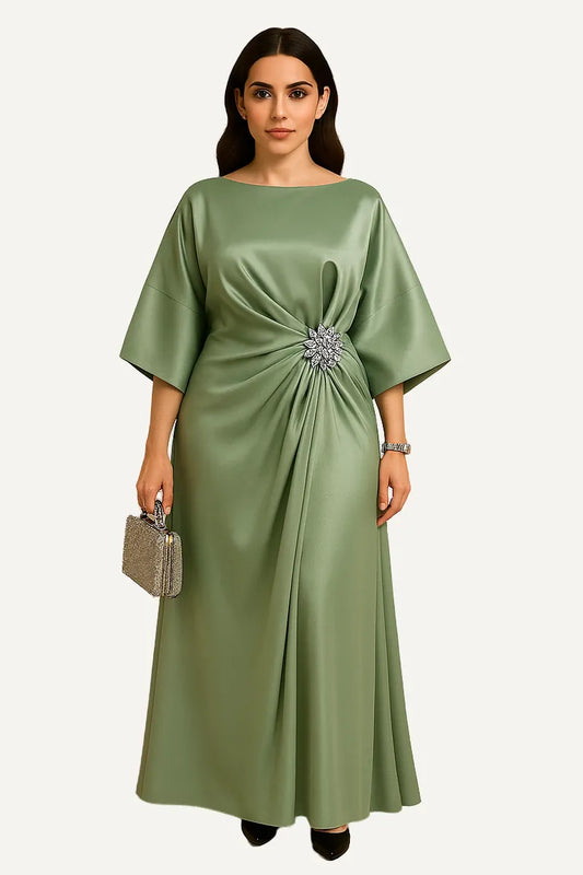 WAROODI Elora Satin Gown in Sage Green – boat neckline, sculpted sleeves, draped front panel, and crystal waist brooch.